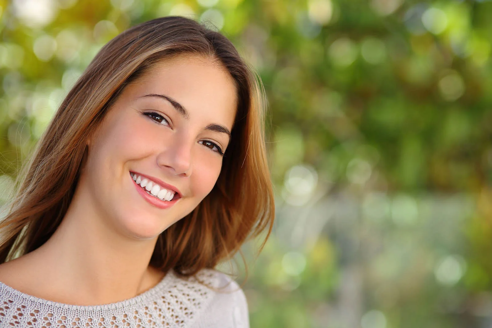 Young orthodontic patient smiling in the dental chair